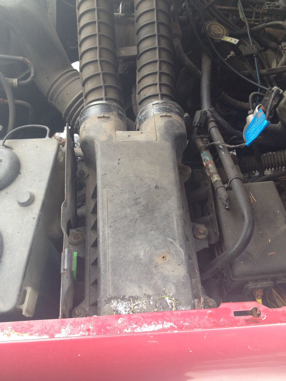 Engine air intake assembly with dual ribbed hoses