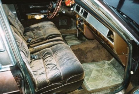 1984 Mercury Grand Marquis - The plush velour seats and wood-grain dashboard trim are visible in this car's interior.