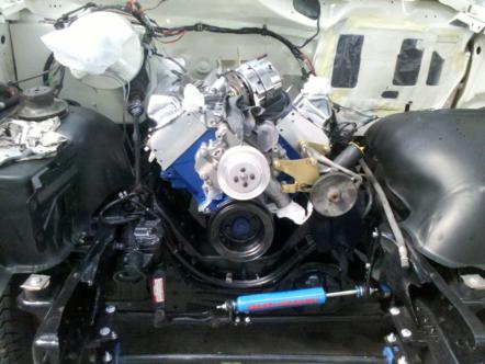 1982 Ford Bronco - The engine compartment of a vehicle shows a V8 engine with various components and wiring.