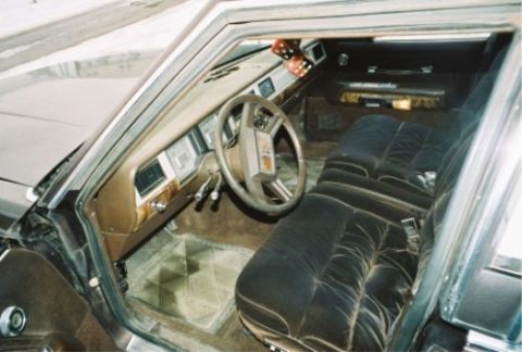 1984 Mercury Grand Marquis - The interior of a car shows plush seating and a dashboard with wood trim, suggesting a model from the early 1980s.