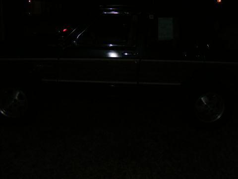 Dark SUV side view at night