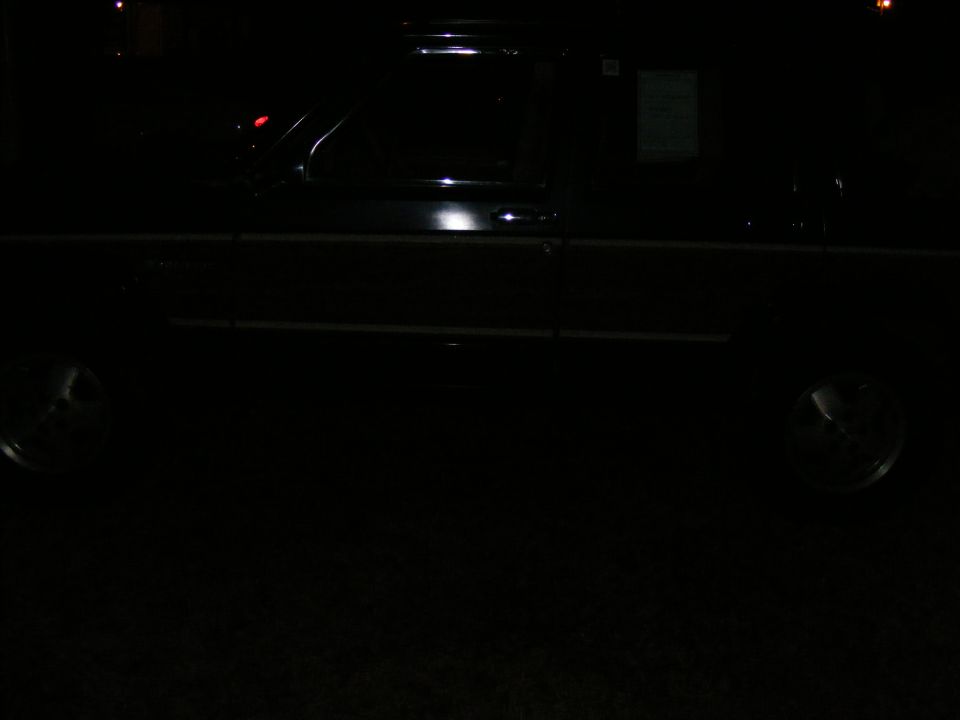 Dark SUV side view at night