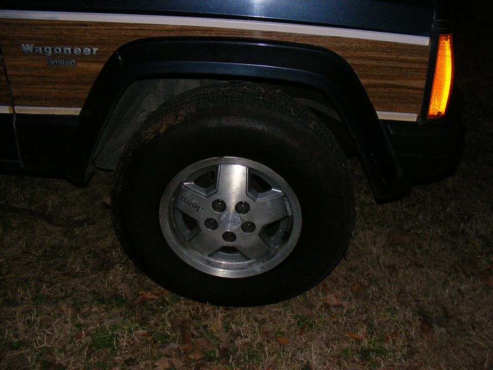 Jeep Wagoneer Limited with wood paneling and a five-spoke wheel
