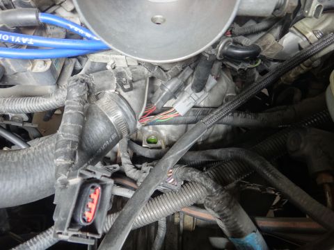 1993 Ford Taurus - A close-up view of a vehicle's engine bay, focusing on the complex network of wires and hoses.