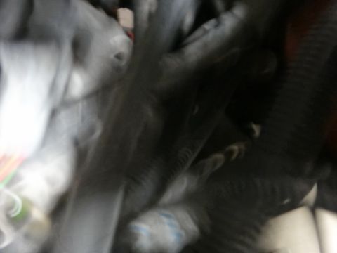 1993 Ford Taurus - The image shows a blurry view of engine components, making identification difficult.