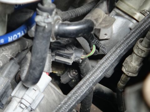 1993 Ford Taurus - Close-up view of an engine sensor with visible wiring and connectors.