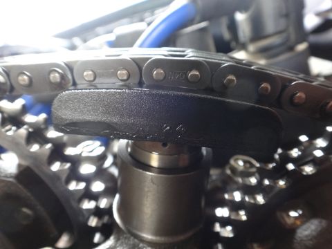 1993 Ford Taurus - Close-up view of a vehicle's engine timing chain and gears, showing some stamped markings.