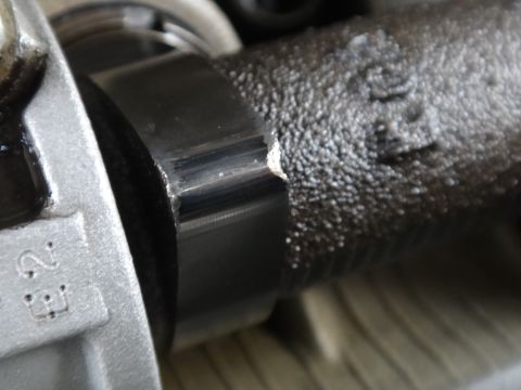 1993 Ford Taurus - A close-up view shows a damaged metal engine part with visible wear and a chipped edge.