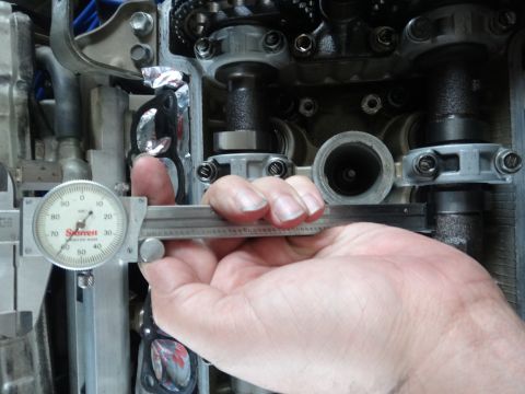 1993 Ford Taurus - A caliper is used to measure a component within an engine's valve train.