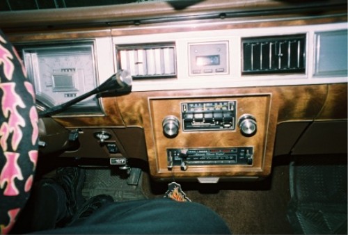 Woodgrain dashboard with center radio and column shifter, interior view