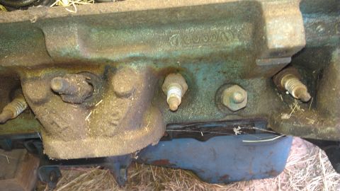 1970 Pontiac Trans Am - Close-up view of an engine block showing spark plugs and cast-in numbers, suggesting a restoration project.