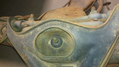 1970 Pontiac Trans Am - Close-up of a rusty vehicle suspension component showing stamped markings.