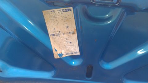 1970 Pontiac Trans Am - A faded and torn sticker is affixed to the underside of a blue hood.