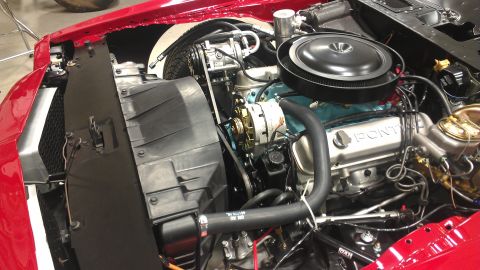 1972 Pontiac Trans Am - Engine bay of a Pontiac V8, showing the air cleaner, alternator, and radiator. The valve cover is stamped with 'PONTIAC'.