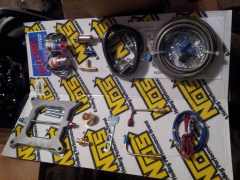 1973 Ford Ranchero - Various components for a NOS Nitrous Oxide System are displayed, including fuel lines, regulators, and a mounting plate.