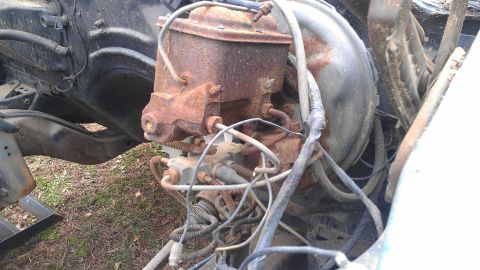 1970 Pontiac Trans Am - Close-up of a rusty brake master cylinder and booster assembly, likely from an older vehicle.
