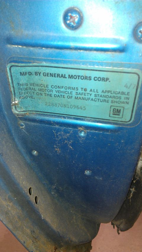 1970 Pontiac Trans Am - A close-up shows a General Motors Corporation identification plate affixed to a blue vehicle's interior panel.