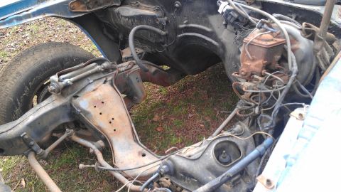 1970 Pontiac Trans Am - Front end of a car frame showing suspension and engine bay parts, no engine installed.