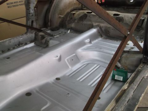 1967 Ford Mustang - The floor pan of a classic car, possibly a 1967 Mustang, is shown during restoration work.