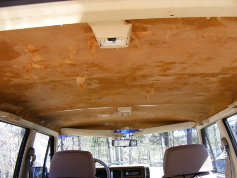 Interior ceiling with peeling headliner and overhead lights