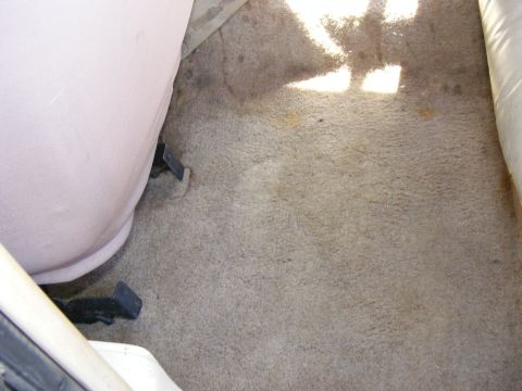Carpeted floor and seat base inside a vehicle