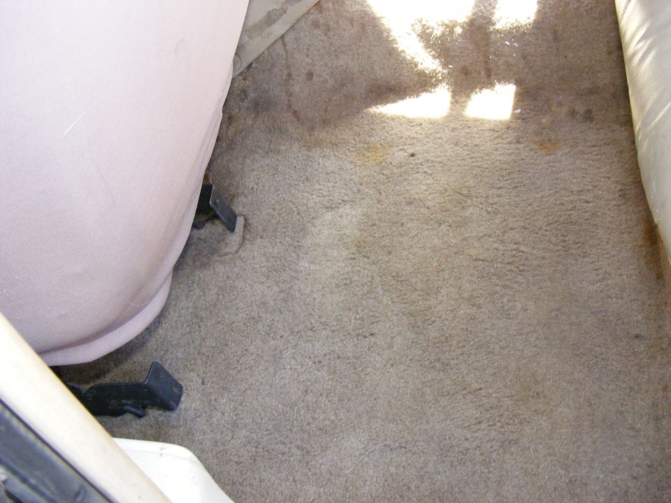 Carpeted floor and seat base inside a vehicle