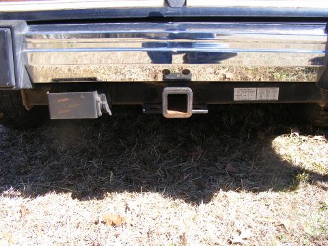 Rear bumper with trailer hitch and visible text labels