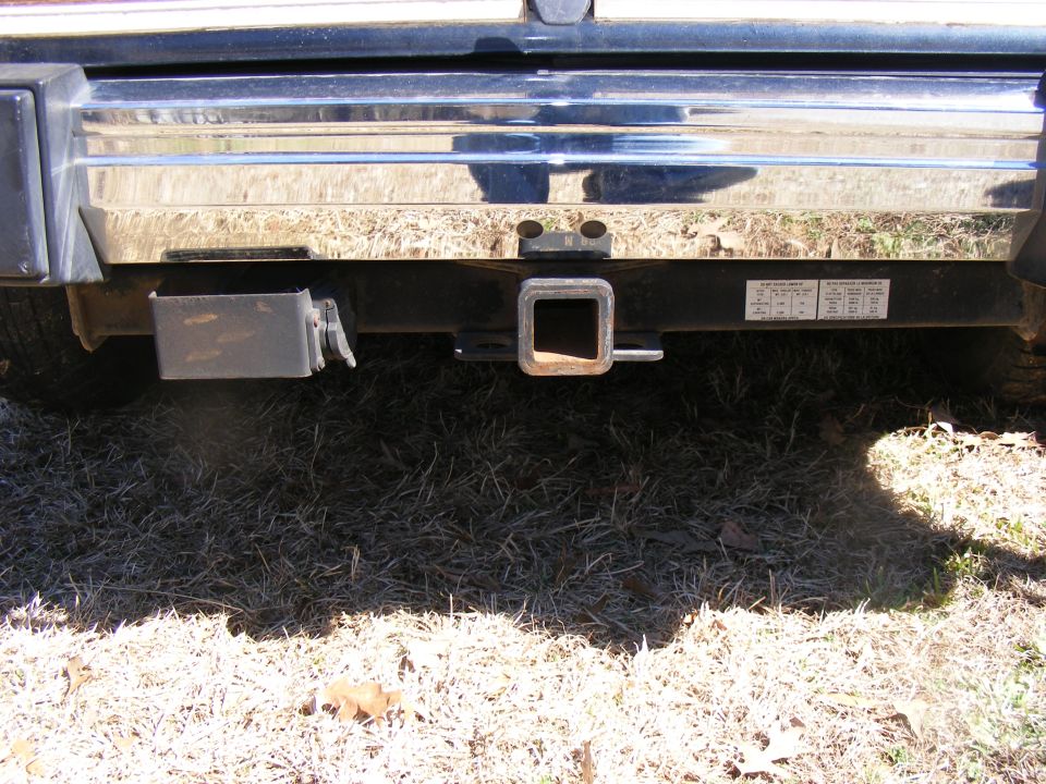 Rear bumper with trailer hitch and visible text labels