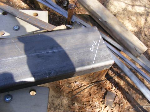 Metal tubing with chalk marks indicating a cut line