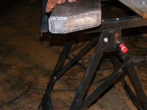 Metal tube with visible welds on a black sawhorse
