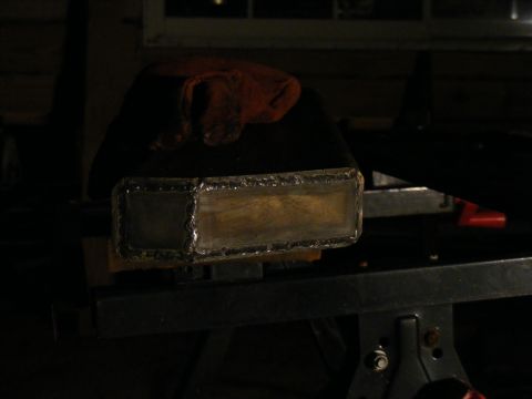 Welded metal rectangular part on a workbench