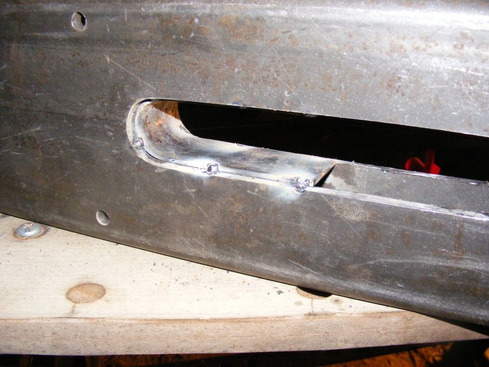 Metal bumper section with welded cutouts and visible Supermotors.net logo