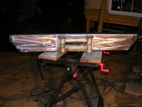 Custom steel bumper with a rusty winch mounted on a black sawhorse