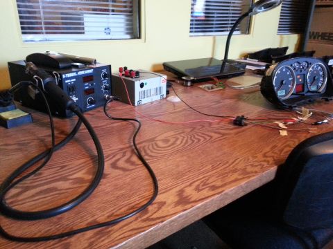 2002 Volkswagen Jetta - A car's instrument cluster is wired to electronic testing equipment on a workbench.