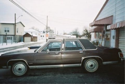 1984 Mercury Grand Marquis - This Ford LTD Crown Victoria is parked on a snowy street in front of a building.