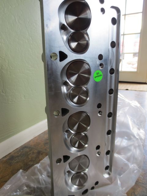 1996 Ford Bronco - Aluminum engine cylinder head with QC Approval sticker, likely a performance part.