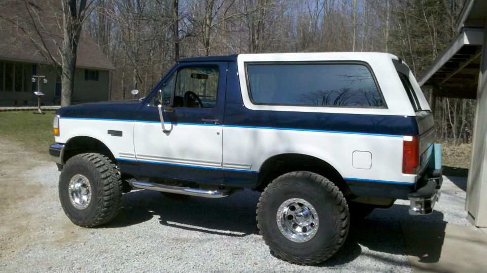 1994 Ford Bronco, two-tone blue and white, lifted with aftermarket wheels