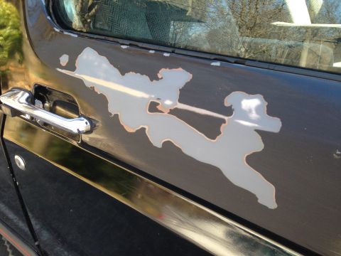 1990 Ford Bronco - Peeling paint on the side door of a 1990 Ford Bronco.