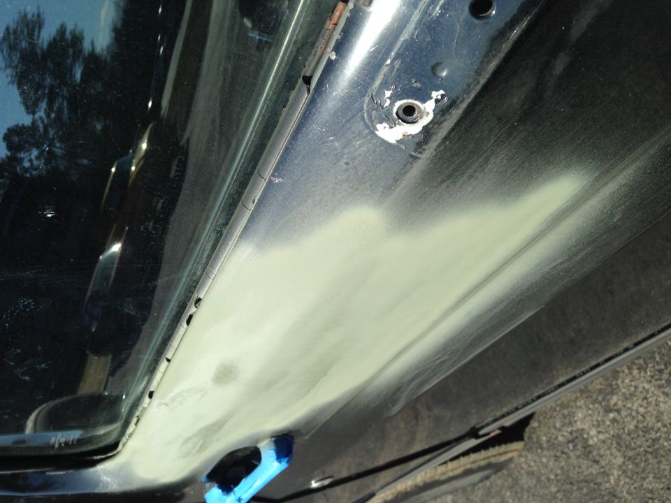 close-up of car door panel with body filler applied