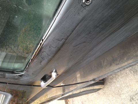 1990 Ford Bronco - Interior door panel detail with window frame and door handle visible.