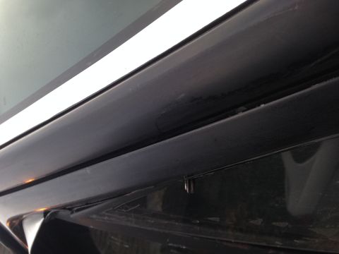 1990 Ford Bronco - Detail shot of the upper trim and window seal on a vehicle.