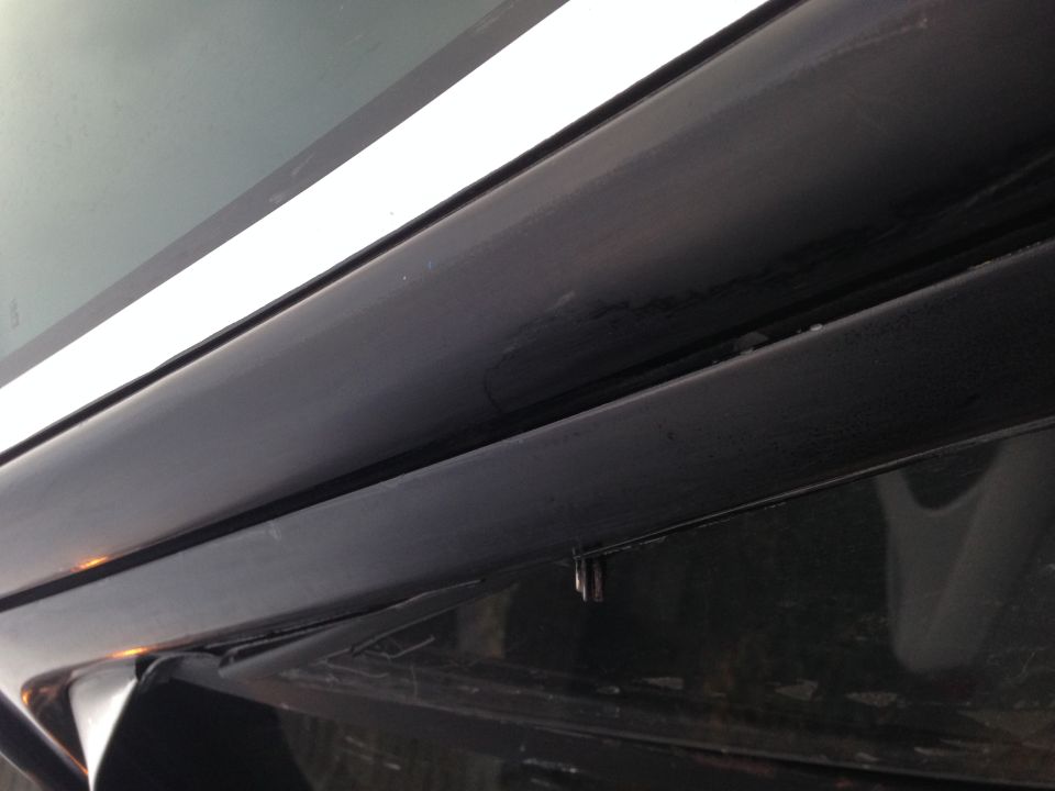 close-up of black trim and white stripe on a vehicle window