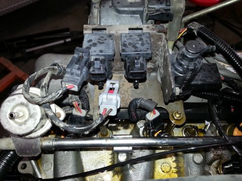 1989 Ford F-150 - Close-up view of Ford fuel injectors and intake manifold components.