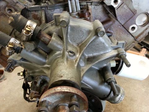 1989 Ford F-150 - Close-up of an engine water pump, showing the Ford logo cast into the housing.