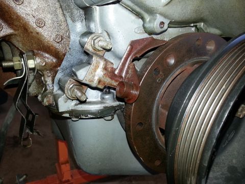 1989 Ford F-150 - Detail of engine components, including a pulley and mounting bracket, with visible signs of age and use.