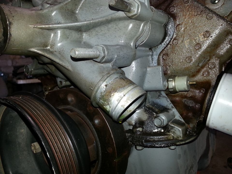 close-up of engine water pump and pulley assembly