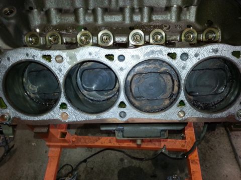1989 Ford F-150 - Close-up view of an engine block's cylinders and pistons, showing wear and carbon buildup.