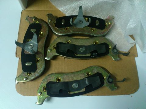 1998 Ford Crown Victoria - Four brake pads are laid out on a cardboard surface, ready for installation.
