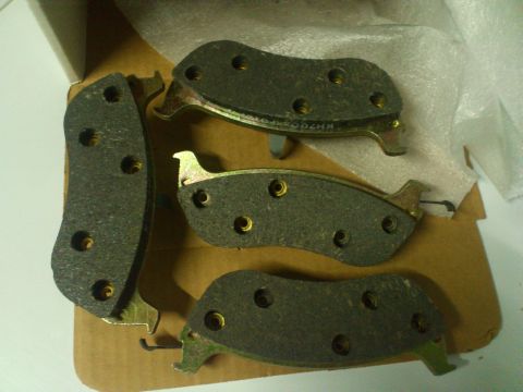 1998 Ford Crown Victoria - Four new brake pads are shown, with a part number visible on one of them.