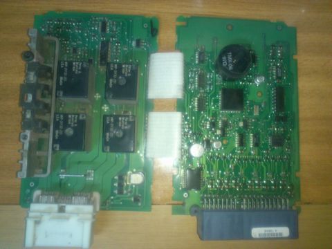 1998 Ford Crown Victoria - Circuit boards with electronic components and connectors are shown laid out on a wooden surface.